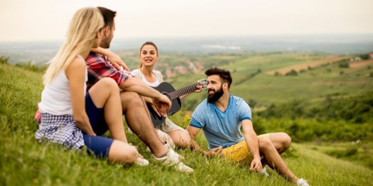 people on hillside with guitar